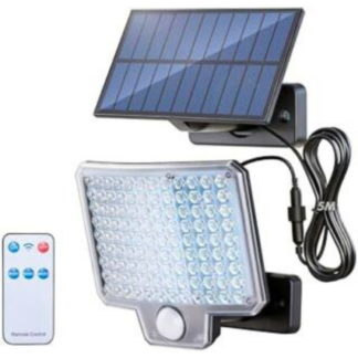 Faretto solare esterno con pannello solare e telecomando GRIFEMA acceso a luce bianca fredda sulla parete esterna di un garage